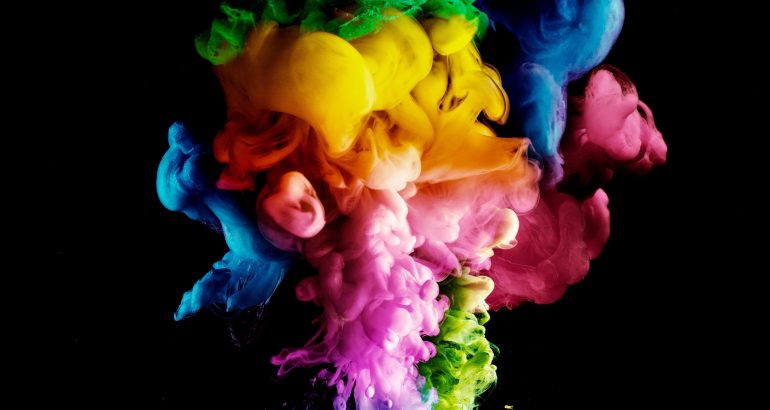 Acrylic colors and ink in water. paint on a black background, th